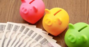 Three,Piggy,Banks,In,Pink,,Green,And,Yellow.,Japanese,Paper
